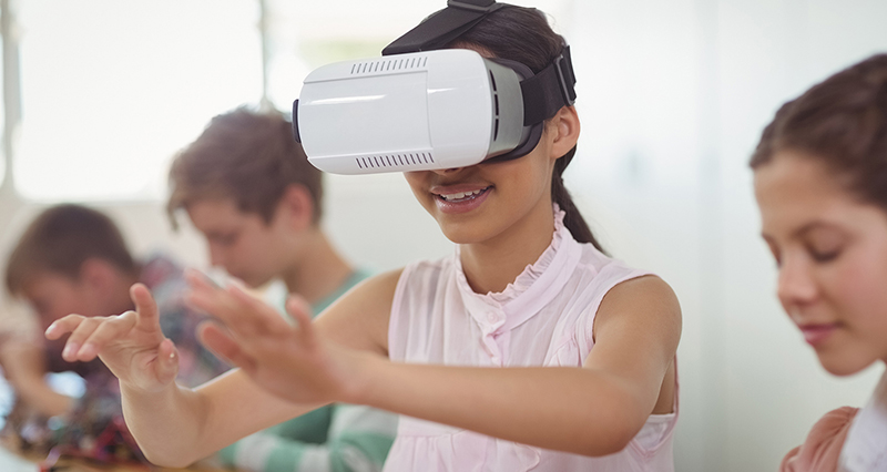 Photo of student with VR goggles