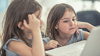 Photo: young children on computer