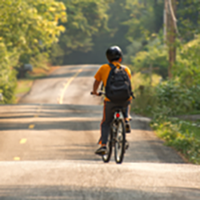 Photo: child cycling down country road